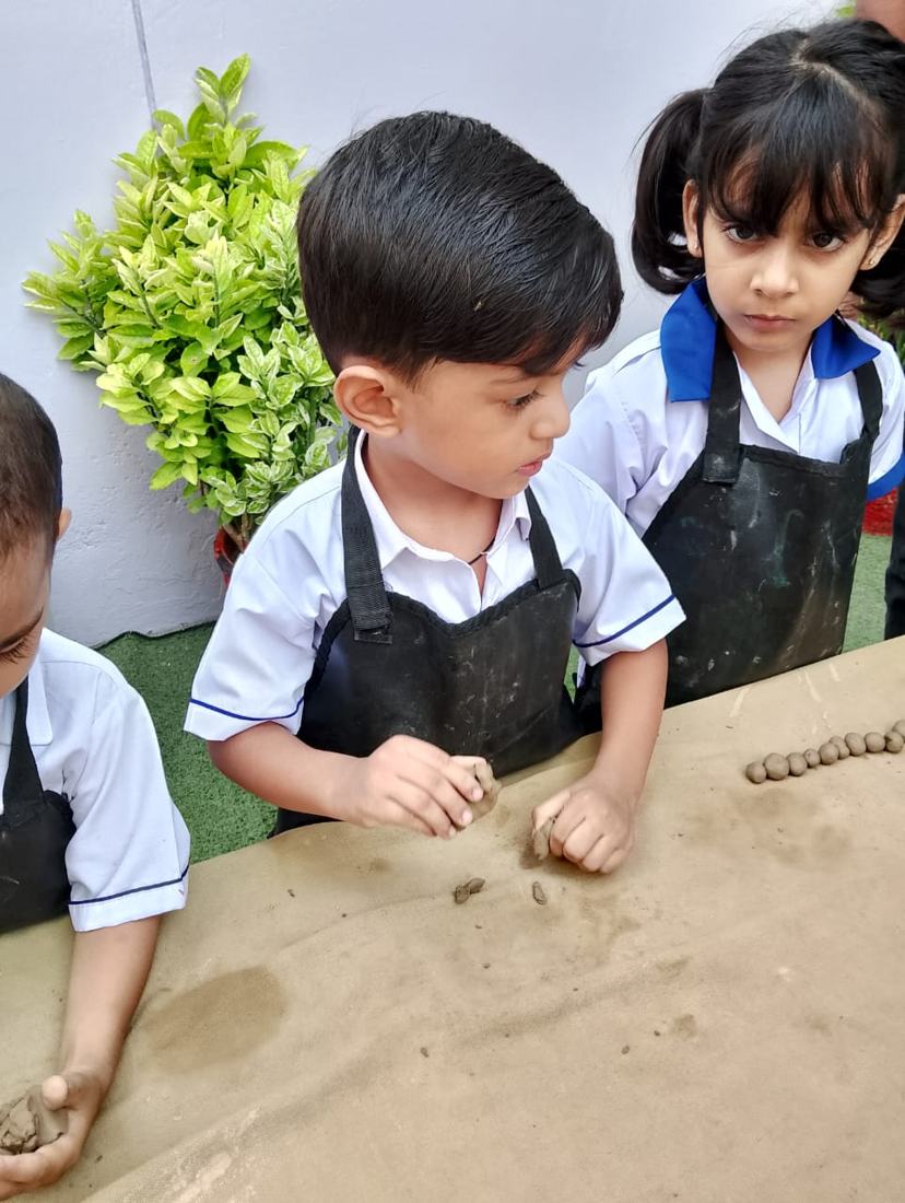 Children shaping clay in an art class